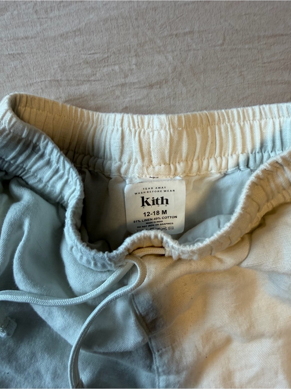Kith Cream Off-White Kids Drawstring Shorts with Navy Trim - Picture 2 of 3